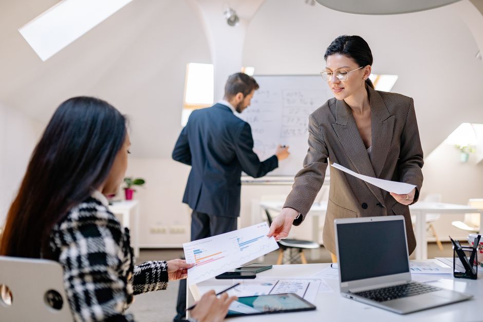 Team members engage in a collaborative planning session in a bright, modern office environment.
